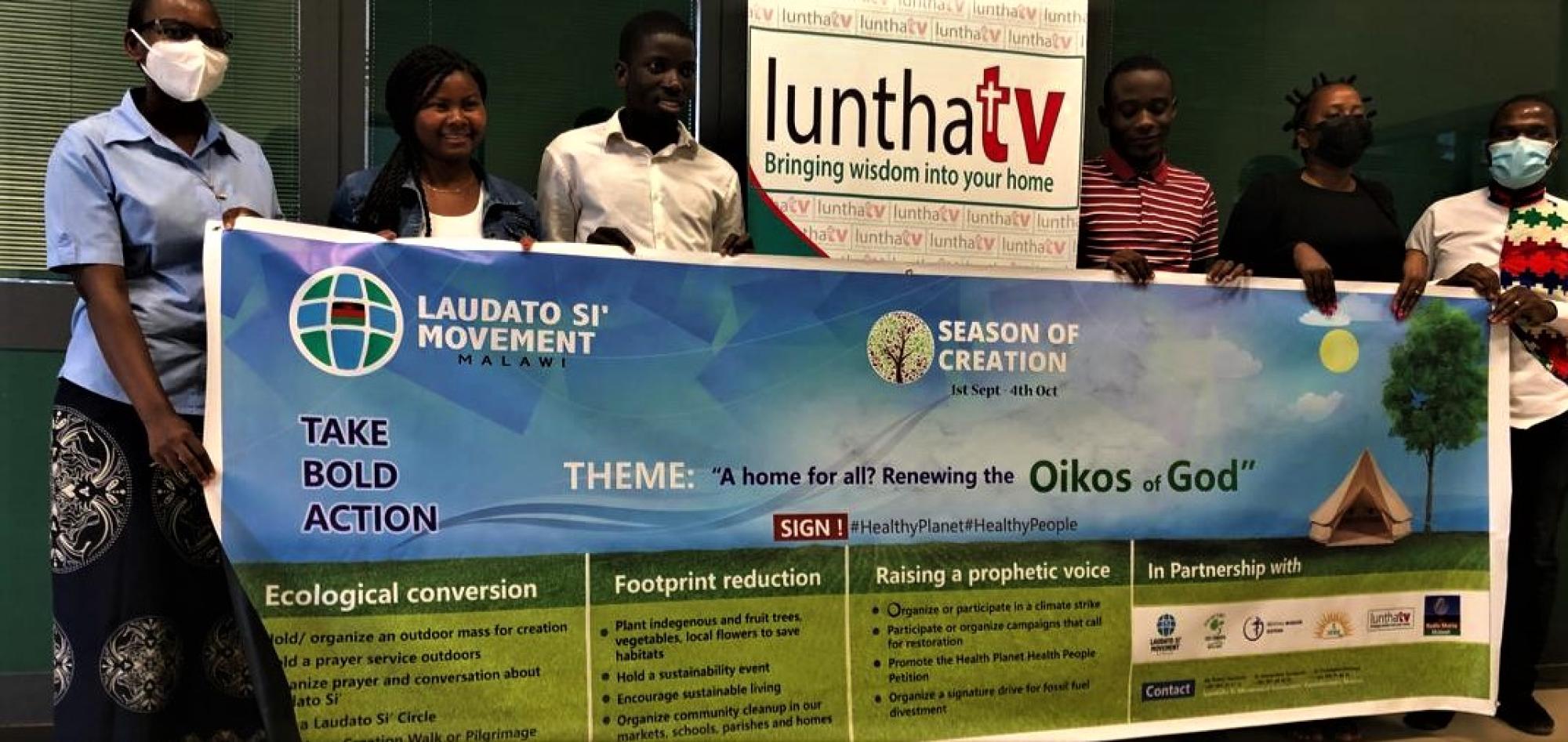 Season of Creation - a banner is help up after a programme is recorded on Luntha TV Malawi