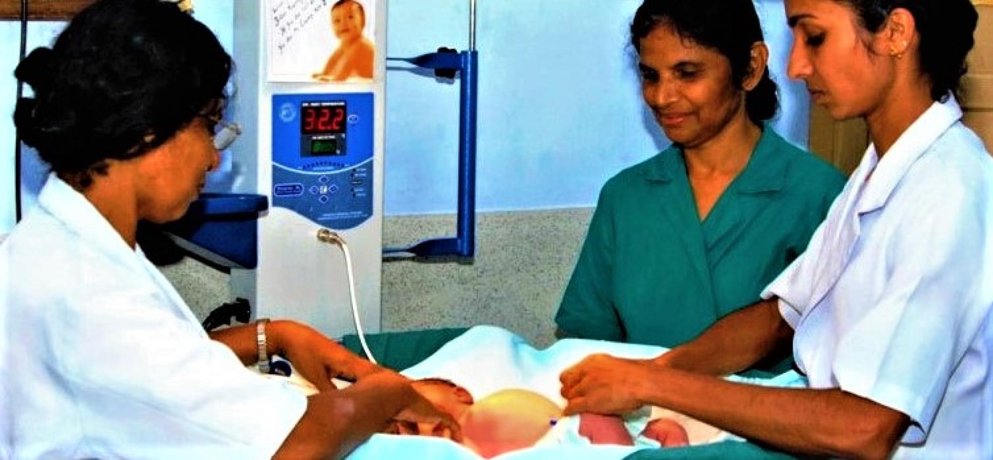 Sister Annie gives care to a newborn in a nursery