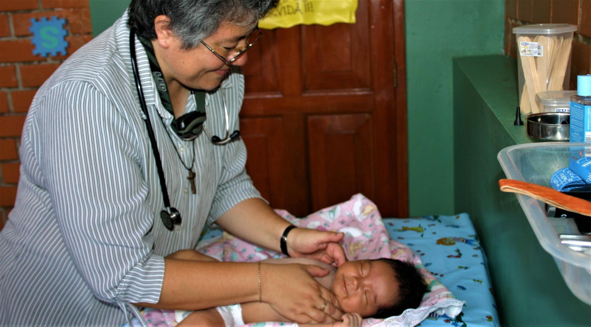 Sister Mafe, a paediatrician, treats a baby