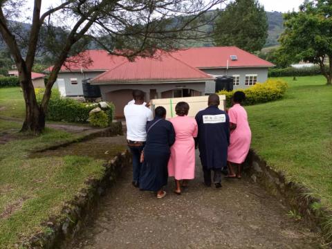 Carrying a new incubator to the maternity unit, Rubanda, Uganda 