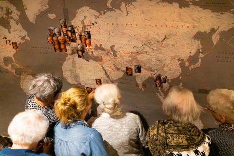 Medical Mission Sisters view the world map where they served at 80th Jubilee