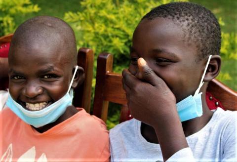Children living with HIV let their masks slip to smile