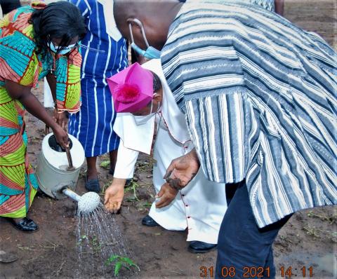 The Bishop of Damongo helps Sister Catherine to plant a tree where the polyclinic will be built
