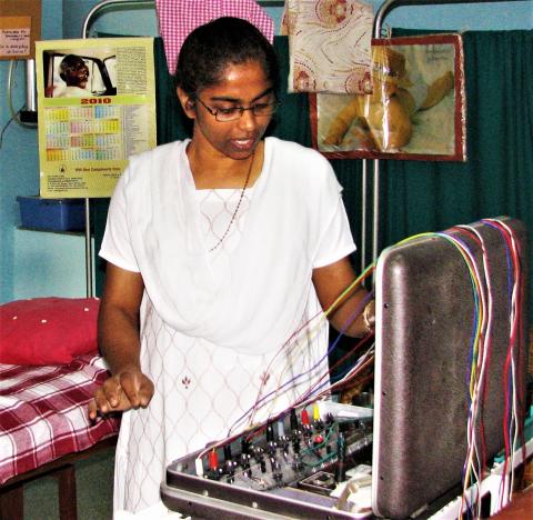 Sister Mary Pakkiam performs acupressure