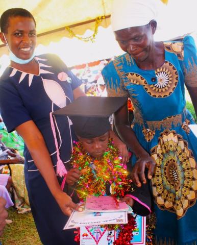 A mother and grandmother share a moment of pride 