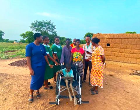 Sitting proudly in a new wheelchair delivered by MMS' public health team