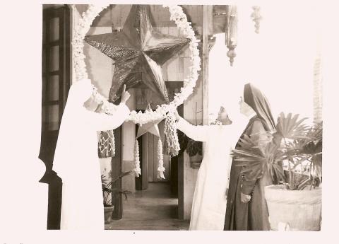 Sr MJ Assumpta shows Mother Dengel the Christmas Star lantern in San Jose, The Philippines, 1963