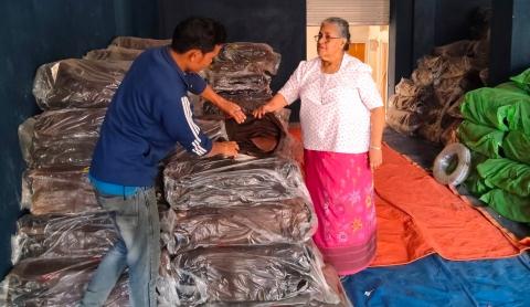 Sister Rose supervises the cooperative's rubber stock 