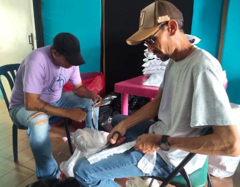 Local men and boys join in the humanitarian efforts