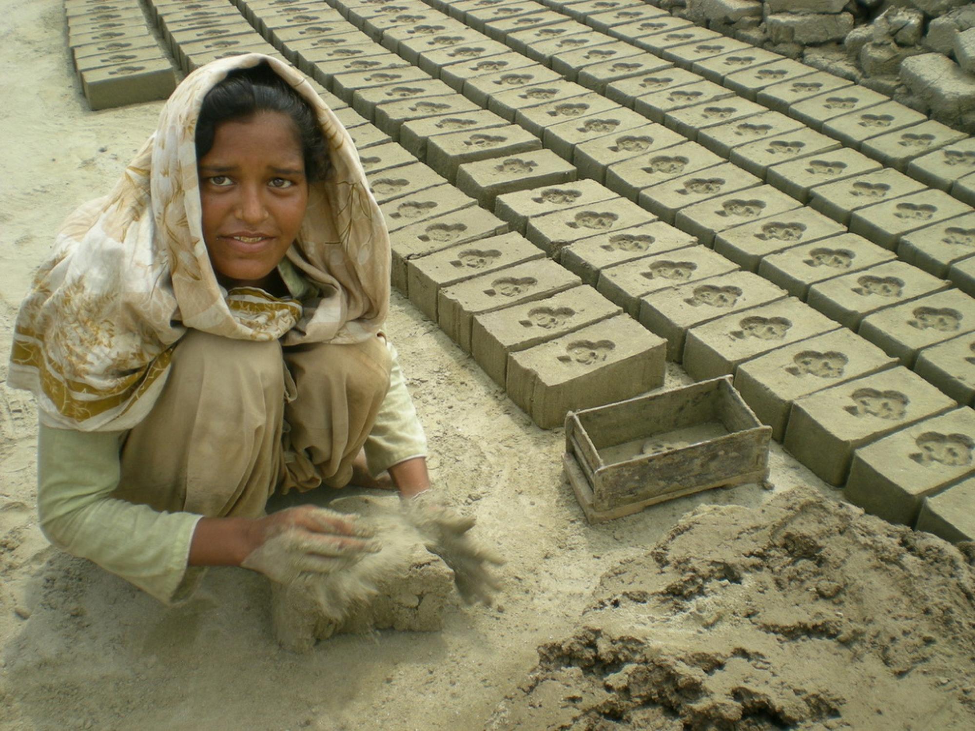 Girl working to make bricks