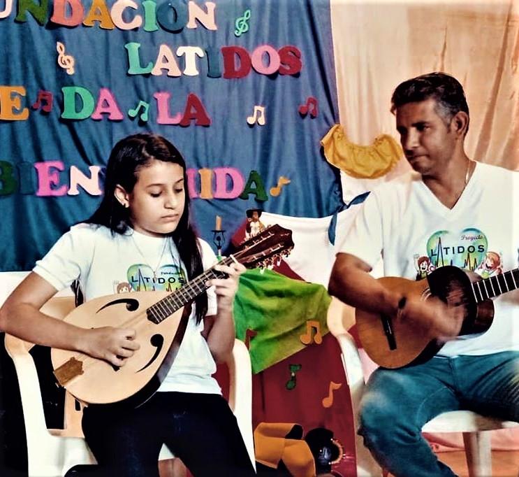 Young Latidos members learns to play her instrument