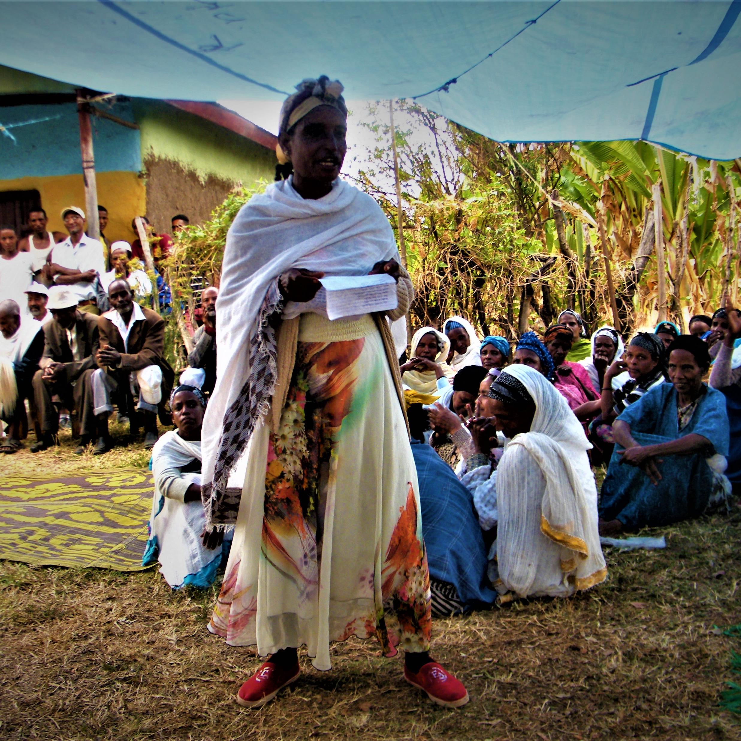 Woman gives a speech to village members, Ethiopia