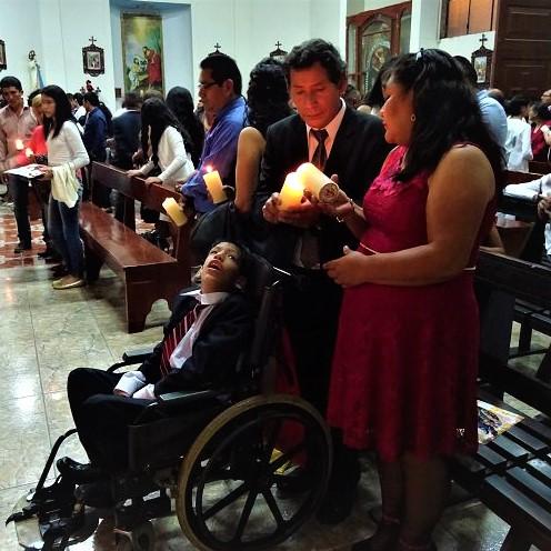 A family of a disabled child praying