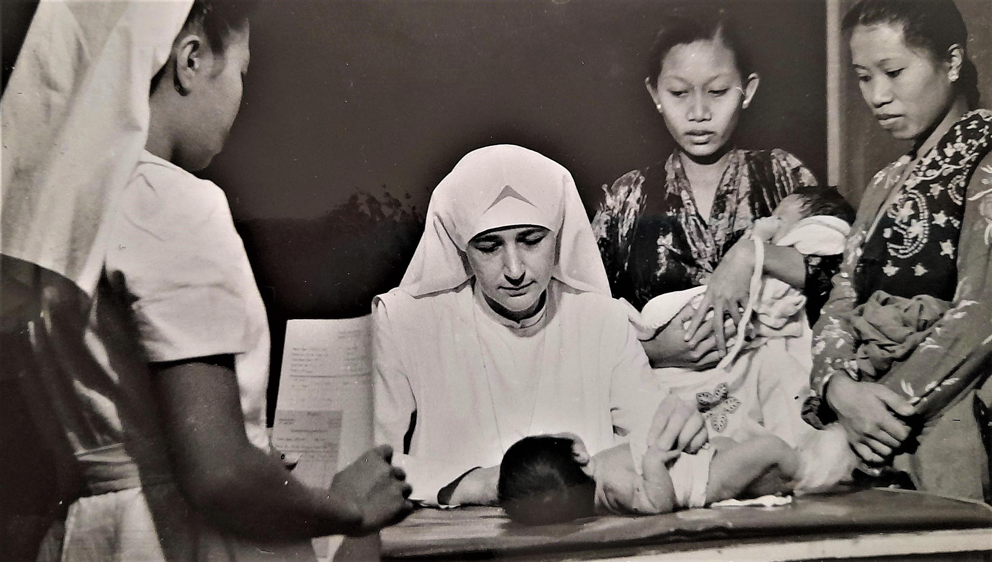 Sister examines a baby