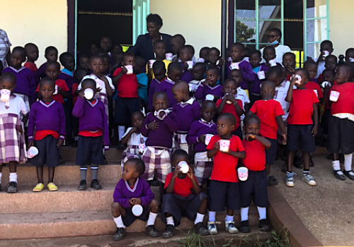 Children enjoying a cup of tea during their break, Anna Dengel Education Centre, Ang'iya, Kenya